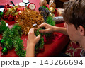 Young Person Making a Christmas Tinsel Wreath at Home 143266694