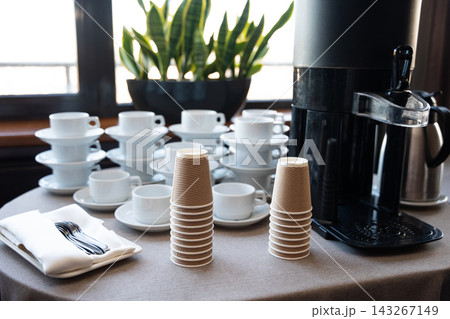 Self-service coffee station with stacks of cups and mugs Self-service coffee station with stacks of cups and mugs 143267149