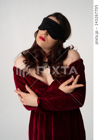 elegant luxury blind woman in evening dress with blindfold posing on white background elegant luxury blind woman in evening dress with blindfold posing on white background 143267705