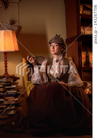 beautiful woman scientist in retro style smokes a pipe in the library reading books beautiful woman scientist in retro style smokes a pipe in the library reading books 143267706