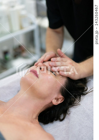 Professional facial massage and skin care treatment in spa salon 143268467