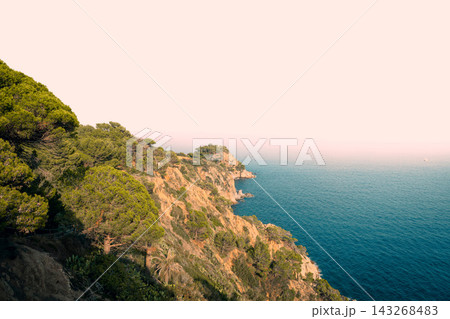 Panoramic view of Tossa de Mar beach and Costa Brava coastline from Vila Vella in Spain. Mediterranean destination for seaside vacations luxury resorts coastal tourism and summer travel Panoramic view of Tossa de Mar beach and Costa Brava coastline from Vila Vella in Spain. Mediterranean destination for seaside vacations luxury resorts coastal tourism and summer travel 143268483