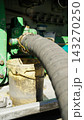 High pressure hose from tanker refuels airplane kerosene at airport 143270250
