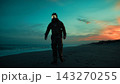 Silhouette of a soldier walking on a radiation-contaminated beach near the ocean 143270255