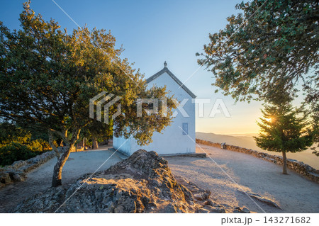 A tranquil summer morning travel scene featuring an old church on a hill with a beautiful sunrise in Douro valley, Portugal. 143271682