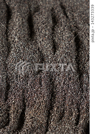 Ground organic poppy seed mix abstract culinary background top down 143273339