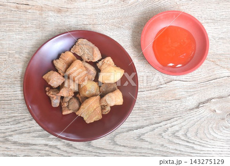 fried salty pork belly with garlic on plate dipping spicy chili sauce 143275129