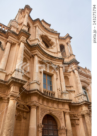 The beautiful Baroque architecture of the facade of the Church of San Carlo in Noto, Sicily, stands out. The beautiful Baroque architecture of the facade of the Church of San Carlo in Noto, Sicily, stands out. 143275794