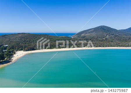 An aerial view across the expansive sandy shoreline of Front Beach at Trial Bay, South West Rocks, New South Wales, Australia. The sweeping bay, turquoise ocean and distant coastal landscape An aerial view across the expansive sandy shoreline of Front Beach at Trial Bay, South West Rocks, New South Wales, Australia. The sweeping bay, turquoise ocean and distant coastal landscape 143275987