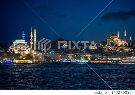 Istanbul,turkey,august 4, 2025. Istanbul night skyline with yeni cami and suleymaniye mosques illuminated along the bosphorus, reflections on the water Istanbul,turkey,august 4, 2025. Istanbul night skyline with yeni cami and suleymaniye mosques illuminated along the bosphorus, reflections on the water 143276059