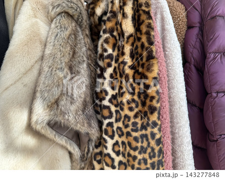 Faux Fur And Leopard Print Winter Coats Hanging Together Indoors Faux Fur And Leopard Print Winter Coats Hanging Together Indoors 143277848