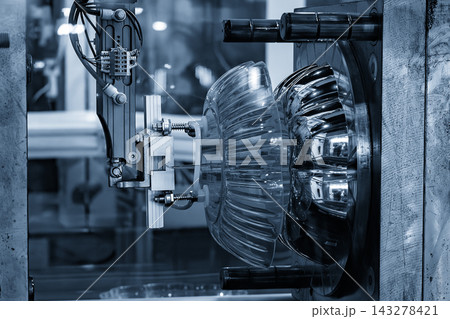 Mass production of high glossy plastic parts by an injection molding machine in a blue tone scene 143278421