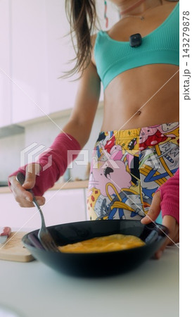 Athletic woman cooking nutritious breakfast in stylish kitchen setting Athletic woman cooking nutritious breakfast in stylish kitchen setting 143279878