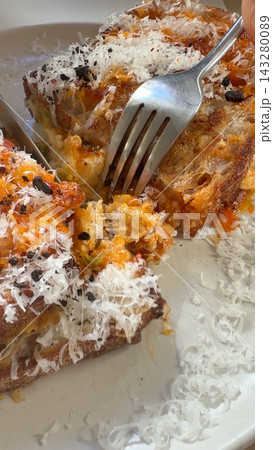 Morning meal featuring crispy sourdough and hearty cheese topping Morning meal featuring crispy sourdough and hearty cheese topping 143280089