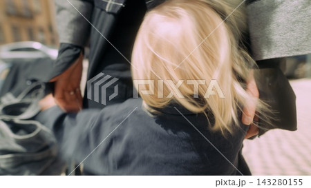 Caucasian child clinging to shopper parent during market stop Caucasian child clinging to shopper parent during market stop 143280155