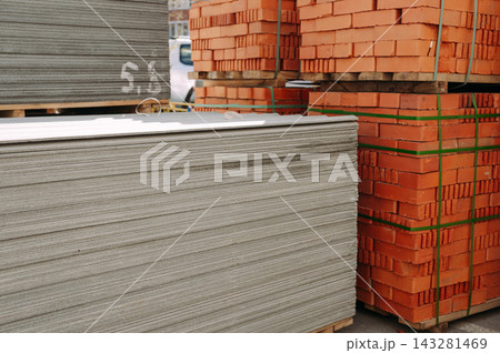 Stacks of bricks and roofing sheets prepared for residential building renovation 143281469