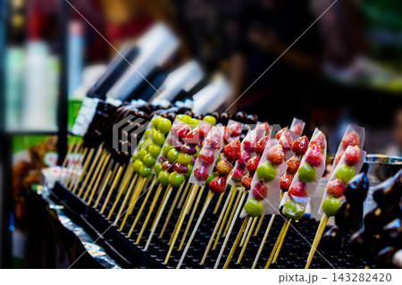 Candied fruit skewers Tanghulu on display at a lively Asian night market 143282420