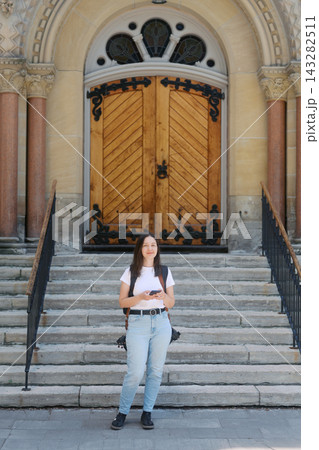 Photographer standing on steps in front of St Andrews Presbyterian Church wooden doors Photographer standing on steps in front of St Andrews Presbyterian Church wooden doors 143282511