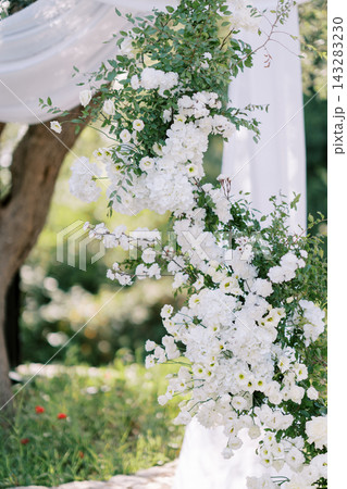 Elegant white floral arrangement for wedding ceremony arch Elegant white floral arrangement for wedding ceremony arch 143283230