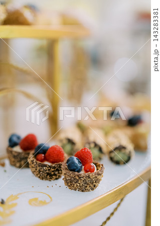 Mini Dessert Cups with Fresh Berries Displayed on Elegant Tray Mini Dessert Cups with Fresh Berries Displayed on Elegant Tray 143283381