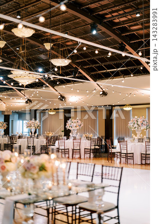 Elegant wedding reception hall with floral centerpieces Elegant wedding reception hall with floral centerpieces 143283991