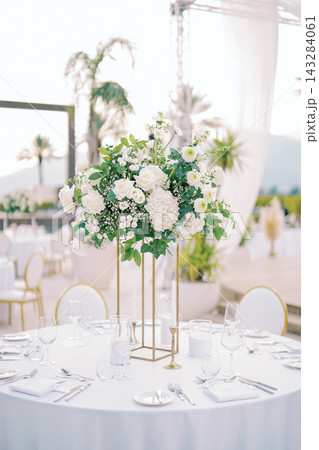 Elegant white floral wedding centerpiece outdoors Elegant white floral wedding centerpiece outdoors 143284061