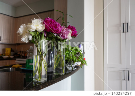 Vases of Peonies on a Modern Kitchen Counter Vases of Peonies on a Modern Kitchen Counter 143284257