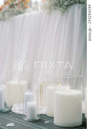 Elegant White Candles in Glass Holders at Event Table 143284294
