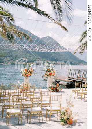 Elegant seaside wedding ceremony setup in Montenegro Elegant seaside wedding ceremony setup in Montenegro 143284382