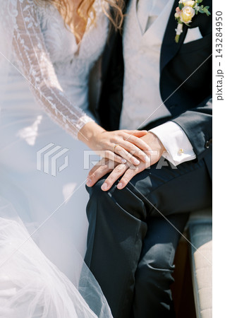 Close up of bride and groom hands during wedding ceremony Close up of bride and groom hands during wedding ceremony 143284950