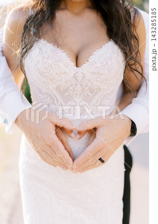 An intimate depiction of lovers sharing sweet gestures amidst soft sunlight and gentle hints 143285185