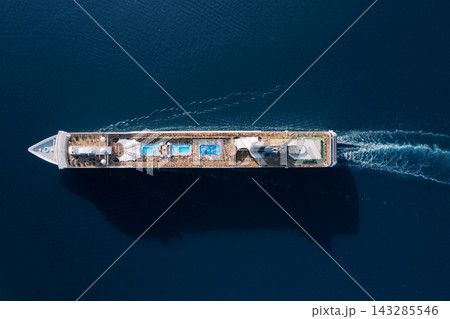 Maritime freight vessel navigating serene azure waters with cargo and containers onboard Maritime freight vessel navigating serene azure waters with cargo and containers onboard 143285546