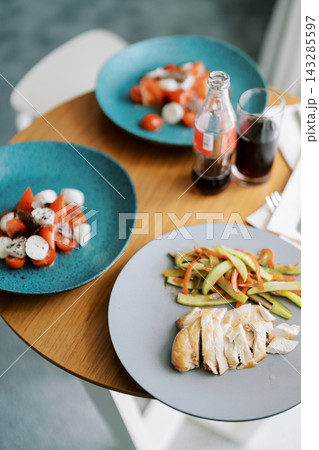 Delicious food presentation. Beautifully arranged grilled chicken accompanied by fresh vegetables Delicious food presentation. Beautifully arranged grilled chicken accompanied by fresh vegetables 143285597