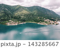 Serene Coastal Scene. Peaceful Seaside Village With Reflective Water And Surrounding Greenery 143285667