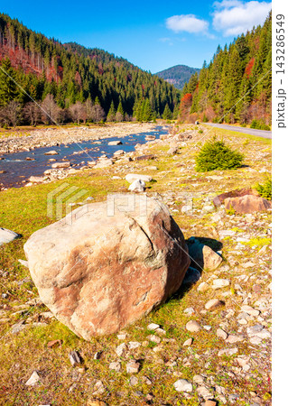 landscape with mountains, forest and a river in front. beautiful autumn scenery in the valley of Synevyr national park, Ukraine landscape with mountains, forest and a river in front. beautiful autumn scenery in the valley of Synevyr national park, Ukraine 143286549