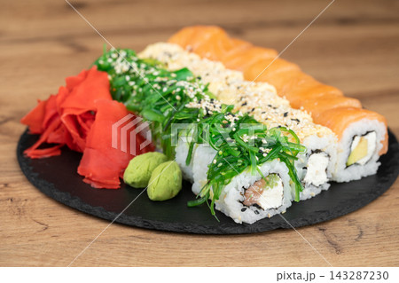 delicious traditional Japanese sushi and rolls on a plate delicious traditional Japanese sushi and rolls on a plate 143287230