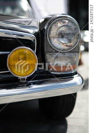 Close-up of a classic vintage black convertible with chrome details Close-up of a classic vintage black convertible with chrome details 143287317