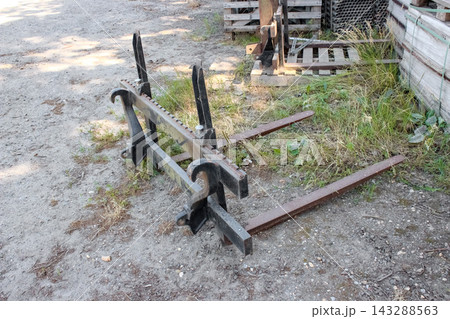 Forklift pallet attachment for loaders, featuring heavy-duty steel forks, a notched adjustable carriage frame, and quick-attach mounting hooks. Forklift pallet attachment for loaders, featuring heavy-duty steel forks, a notched adjustable carriage frame, and quick-attach mounting hooks. 143288563