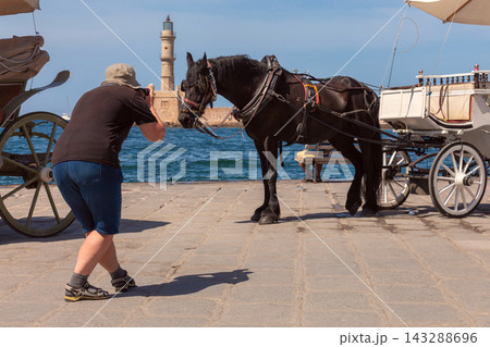 Horse Carriage and Tourist Photographer in Chania, Crete, Greece Horse Carriage and Tourist Photographer in Chania, Crete, Greece 143288696