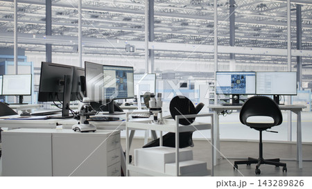 Empty semiconductor engineering office with computers used to analyze microchip architecture systems. Research workspace with digital screens used to develop PCBs for electronics devices, camera A Empty semiconductor engineering office with computers used to analyze microchip architecture systems. Research workspace with digital screens used to develop PCBs for electronics devices, camera A 143289826
