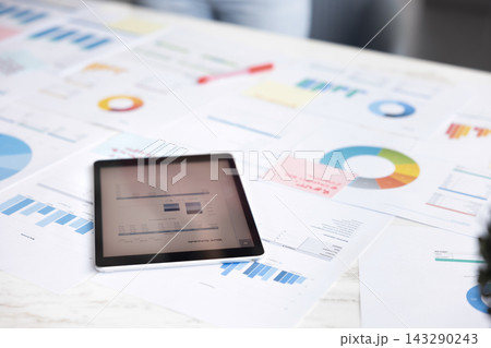 Close up view professional workspace filled with analytical reports papers Close up view professional workspace filled with analytical reports papers 143290243