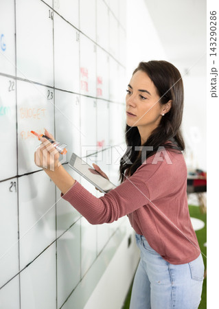 Focused woman prepare schedule for staff members Focused woman prepare schedule for staff members 143290286