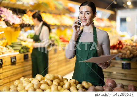 Female seller calls on the phone in the store 143290517