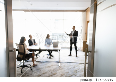 Business team attending briefing in conference room, blurred background Business team attending briefing in conference room, blurred background 143290545