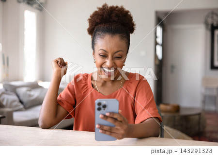 Happy woman celebrates good news received in sms Happy woman celebrates good news received in sms 143291328