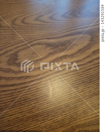 It is a close-up of a wooden table. It is a close-up of a wooden table. 143291584