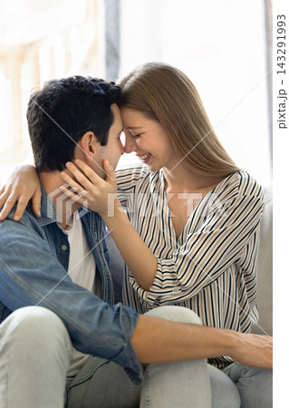 Couple in love touching foreheads and smiling with eyes closed Couple in love touching foreheads and smiling with eyes closed 143291993