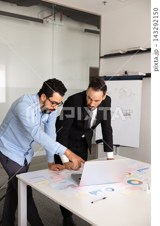 Colleagues working together on marketing strategy using laptop 143292150