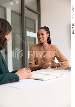African businesswoman conducts meeting with business partner or client African businesswoman conducts meeting with business partner or client 143292266