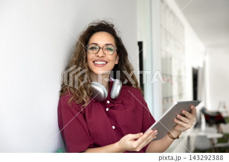 Female freelancer sitting in coworking using digital tablet, portrait 143292388
